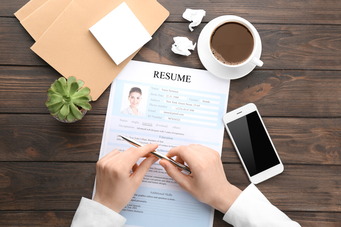 Female Hands Writing on a Resume Form